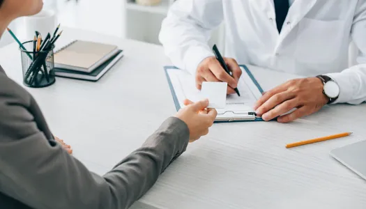 patient handing doctor insurance card