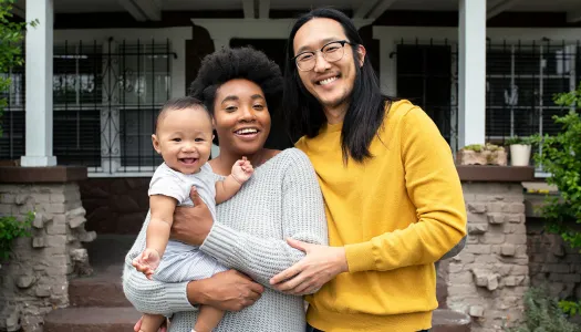 family in front of home