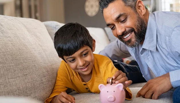 father teaching son to save money