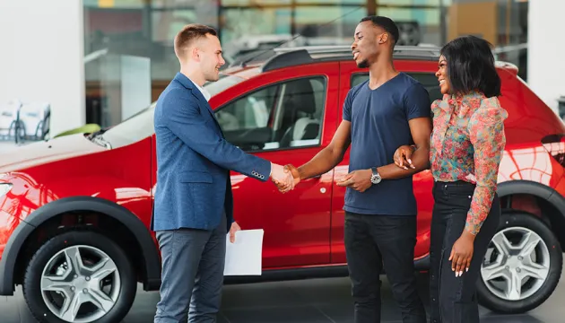 couple buying a red car