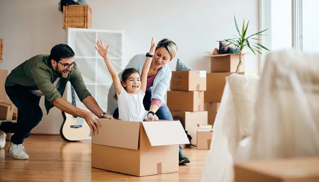 Family playing in room with boxes