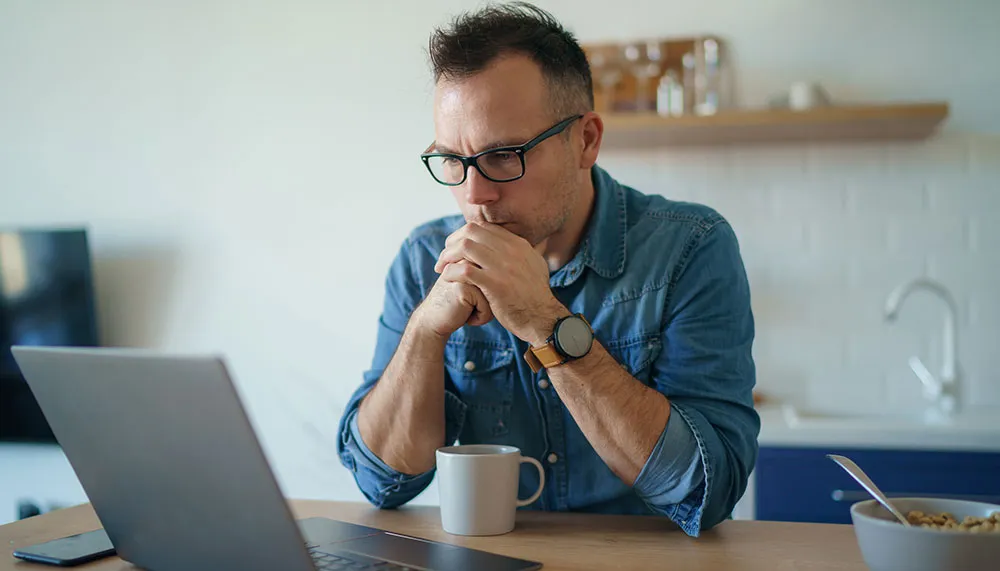 concerned man looking at computer