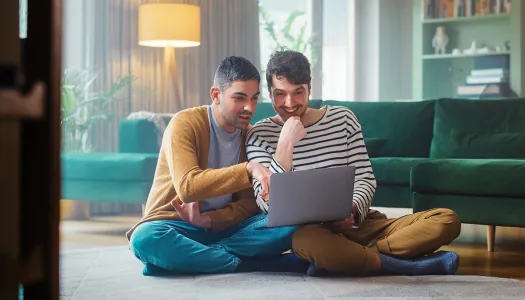 couple checks credit score on computer